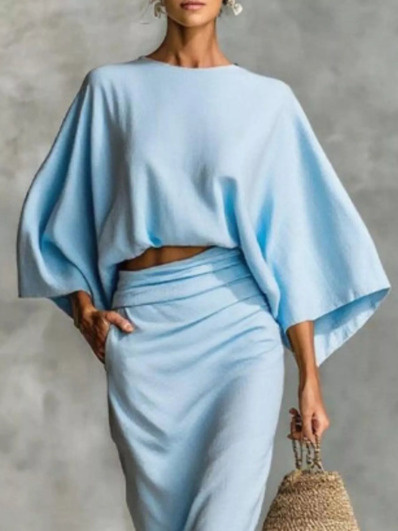 Kimono sleeve top and ruched skirt set in light blue showing fabric texture and draped detail