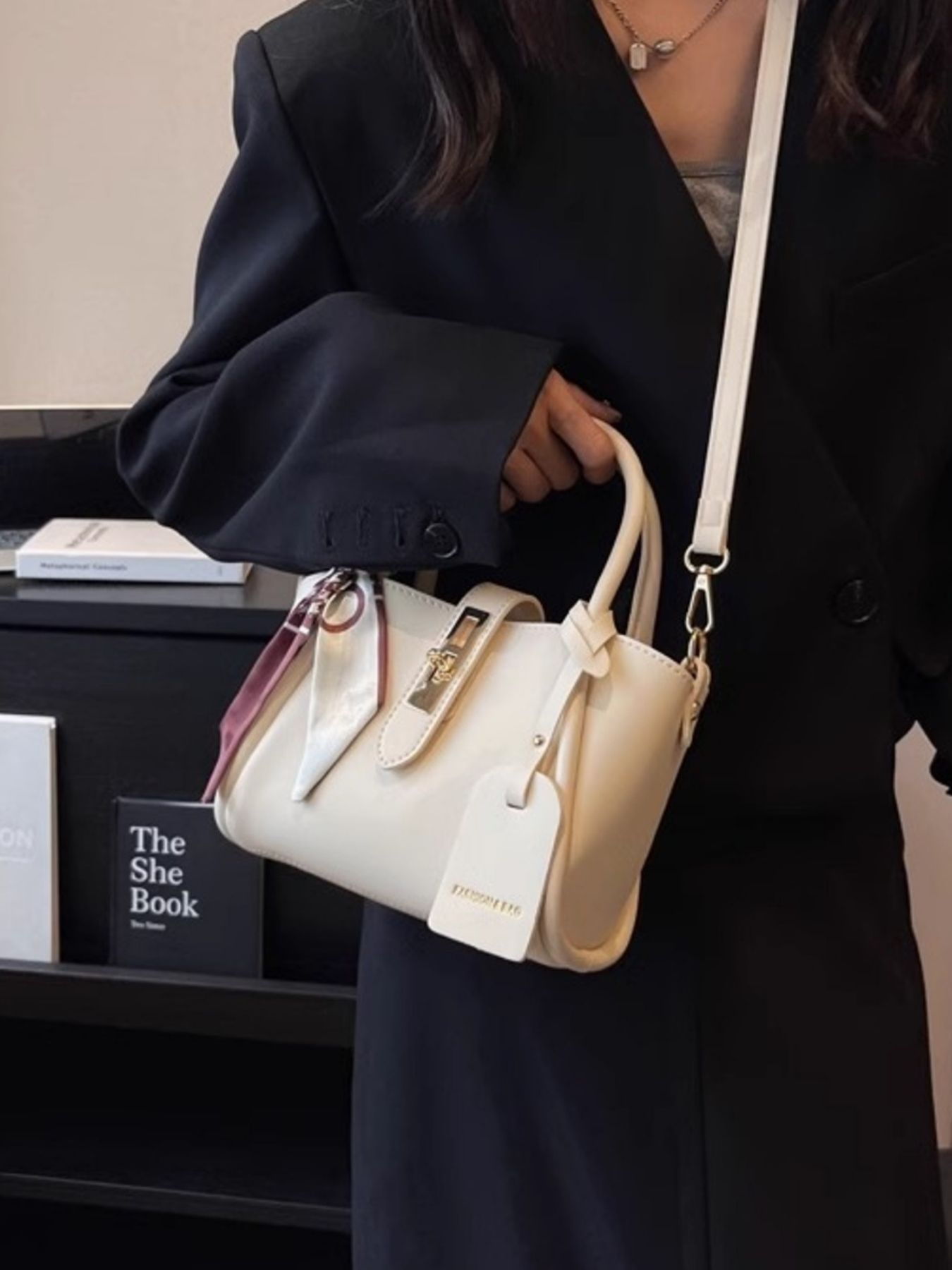 Structured mini satchel crossbody in ivory worn crossbody