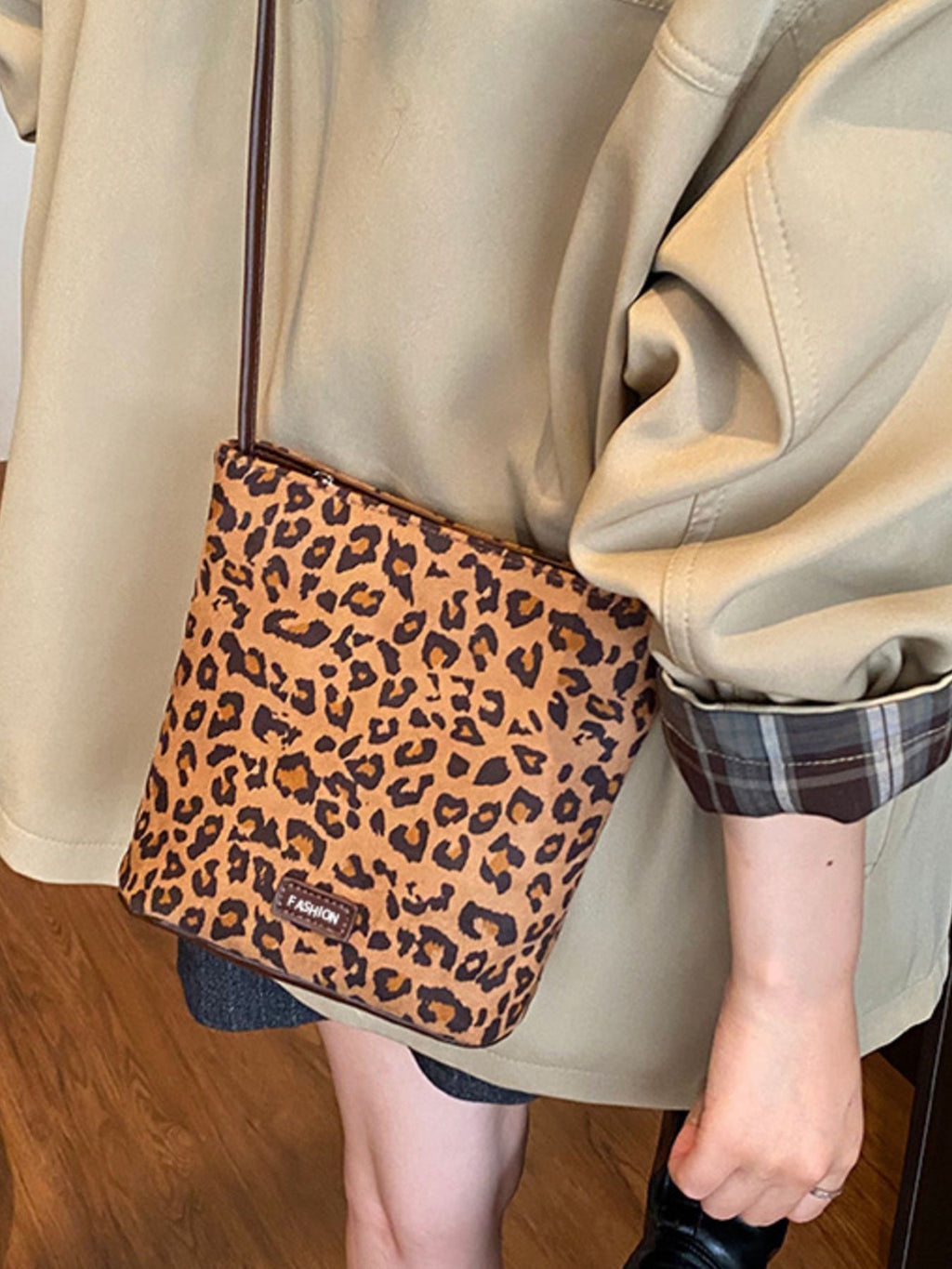 Leopard print crossbody bag slung over shoulder shows size