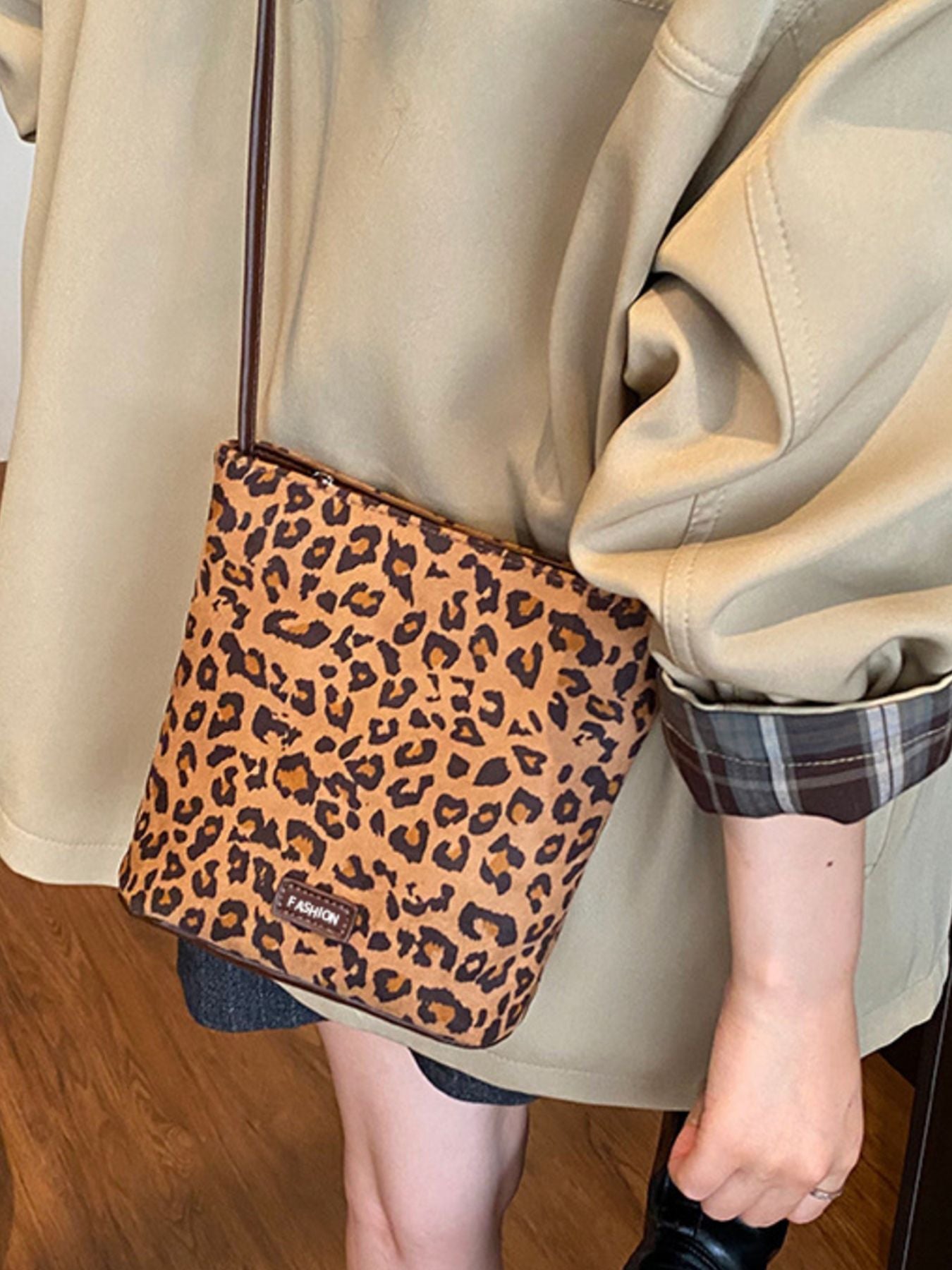 Leopard print crossbody bag slung over shoulder shows size