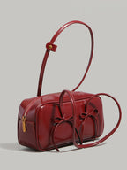 Bow decor shoulder bag with front bow detail, side view with thickness and zipper detail