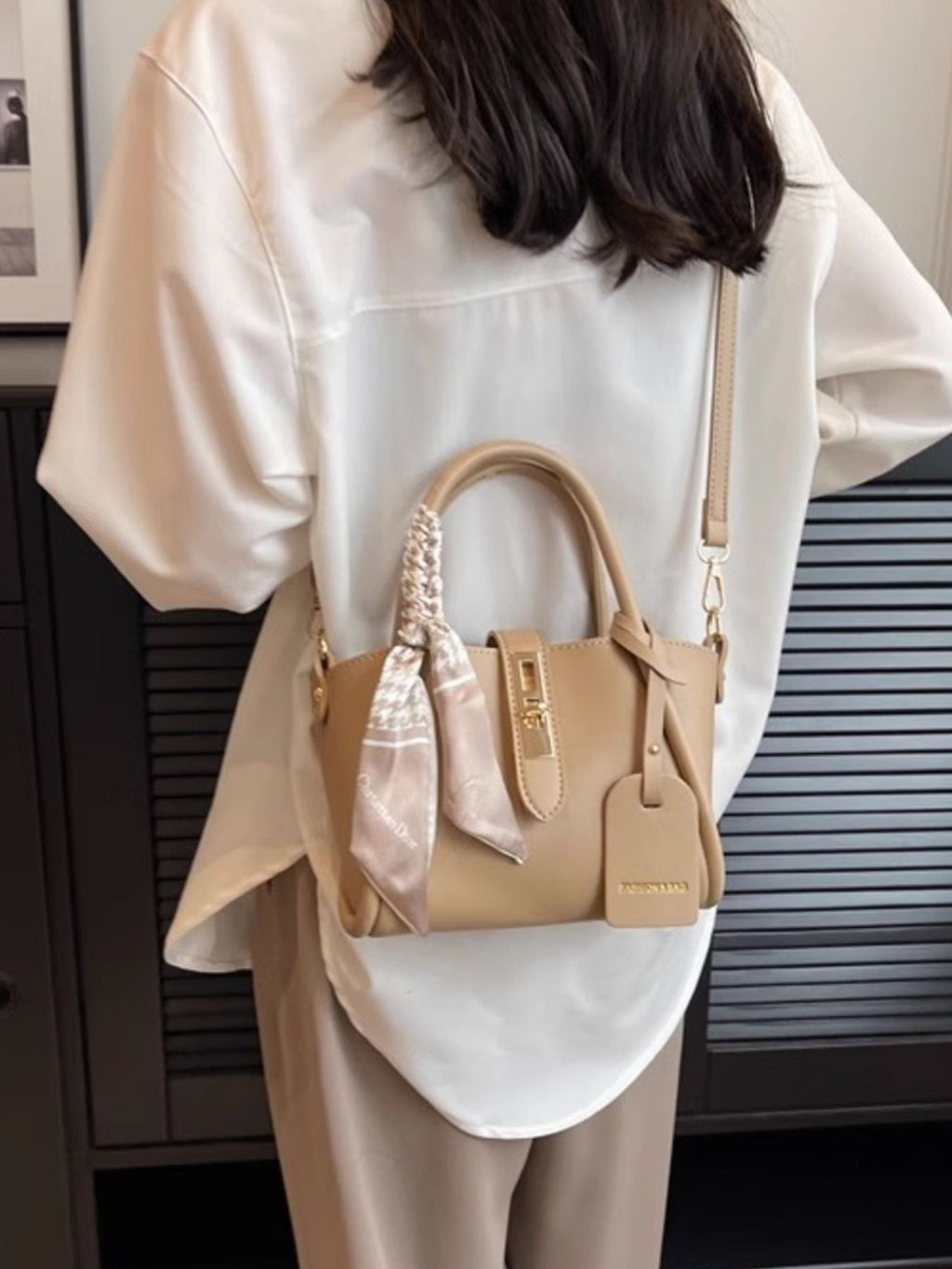 Structured mini satchel crossbody in khaki slung crossbody over back
