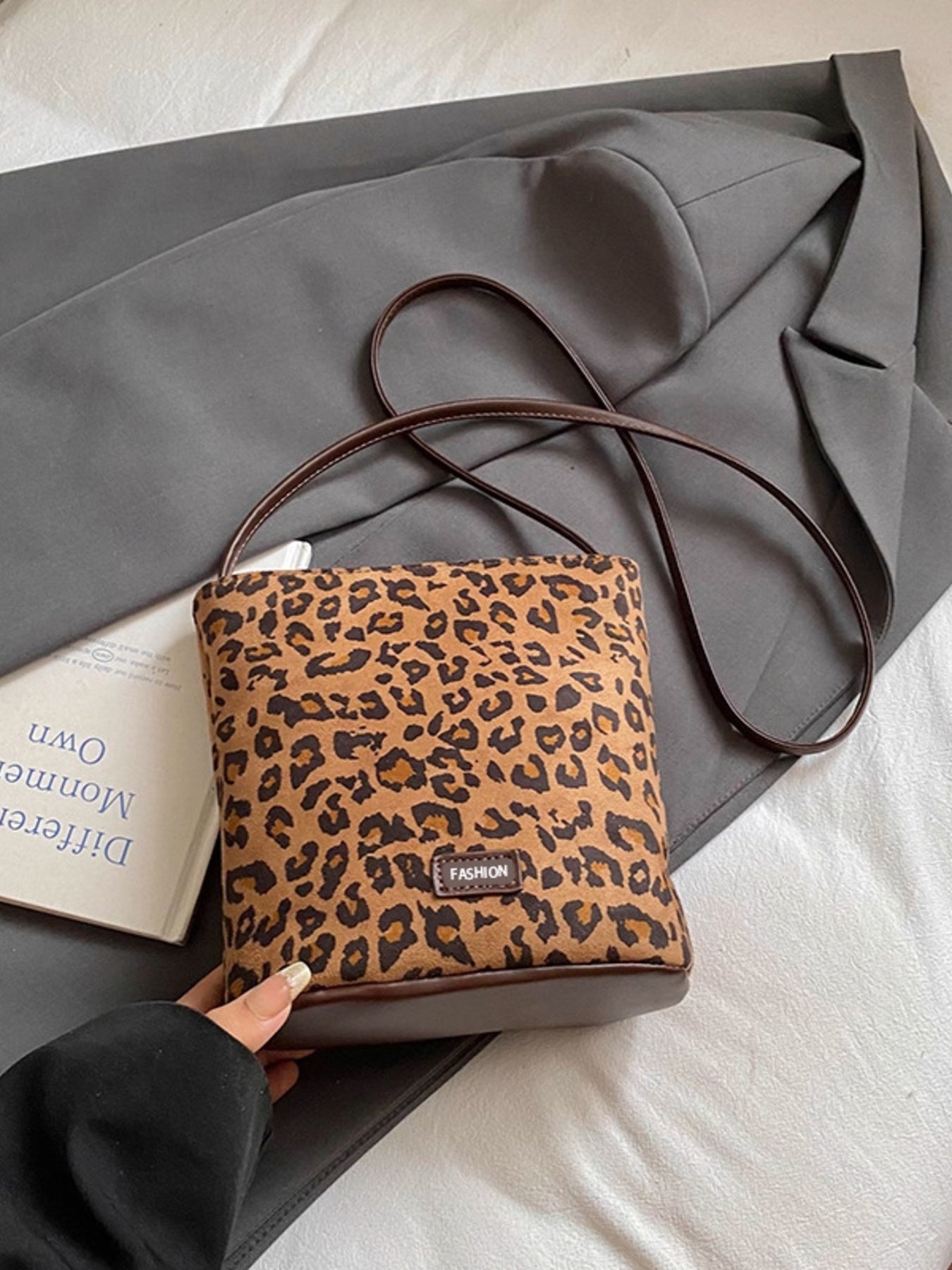 Leopard print crossbody bag laying down, shows front and bottom