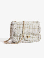 Classic tweed shoulder bag standing alone