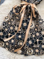floral applique mini dress in black and gold closer skirt view