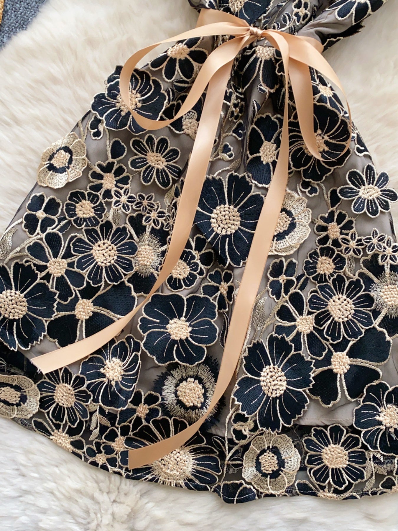 floral applique mini dress in black and gold closer skirt view