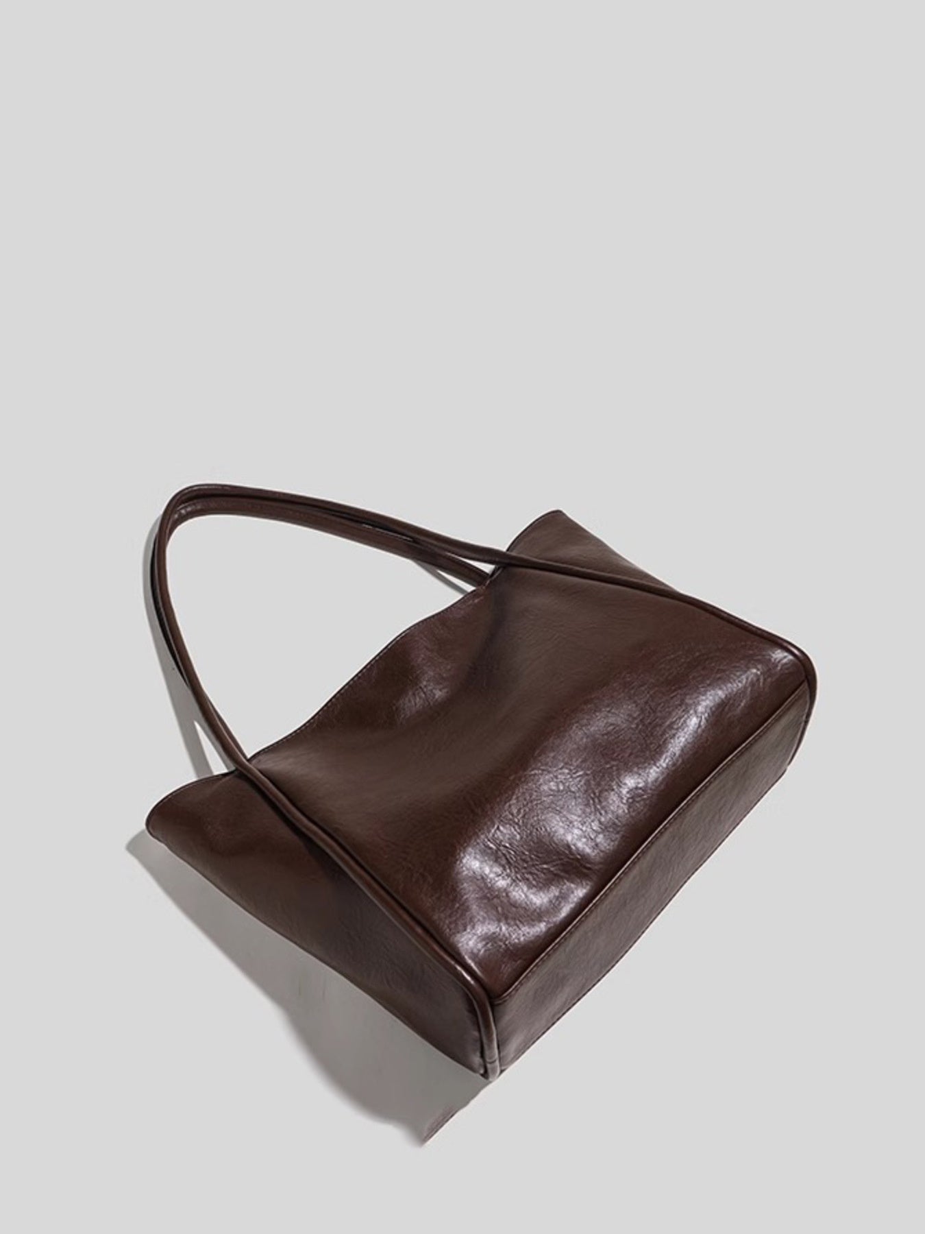 PU leather tote bag with double handles showing side and bottom
