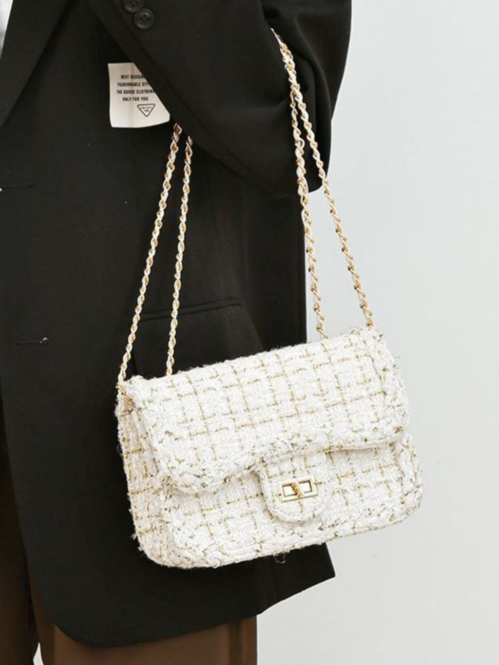 Classic tweed shoulder bag chain doubled slung over arm