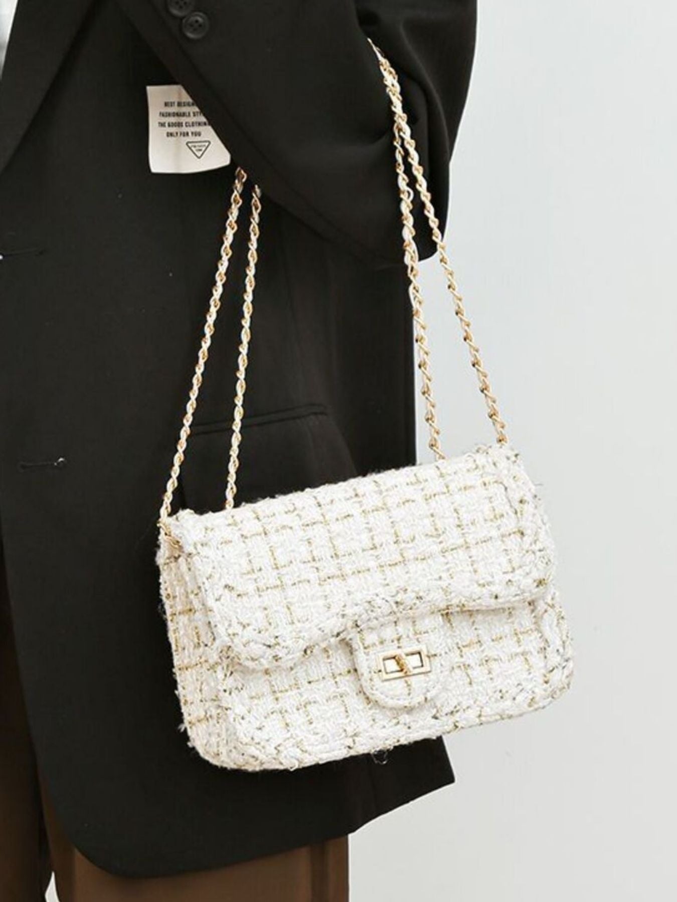 Classic tweed shoulder bag chain doubled slung over arm