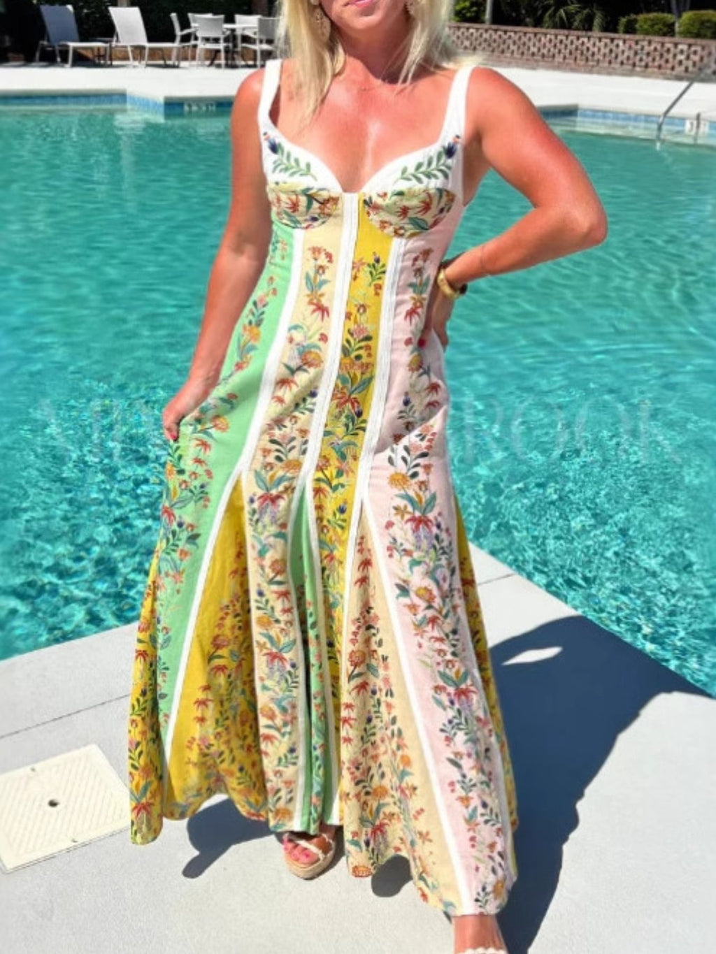 bohemian floral maxi dress in green holding out skirt