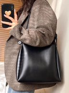 Structured PU leather shoulder bag hanging on shoulder