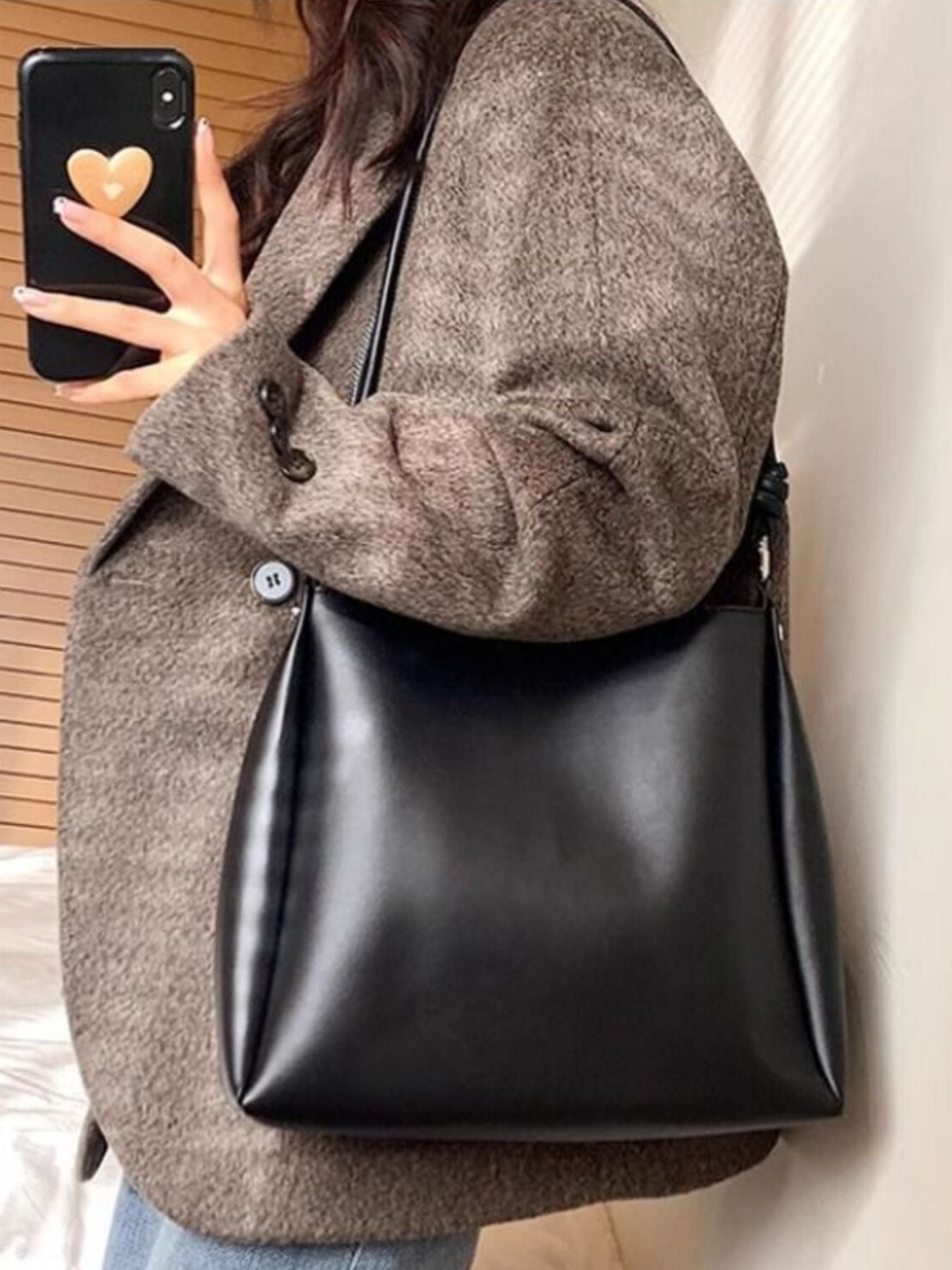 Structured PU leather shoulder bag hanging on shoulder
