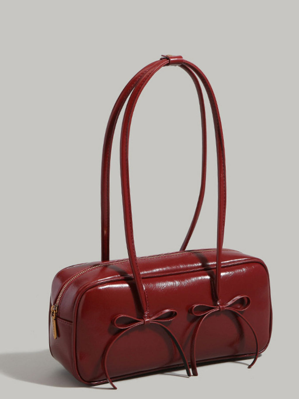 Bow decor shoulder bag with front bow detail shown standing on its own