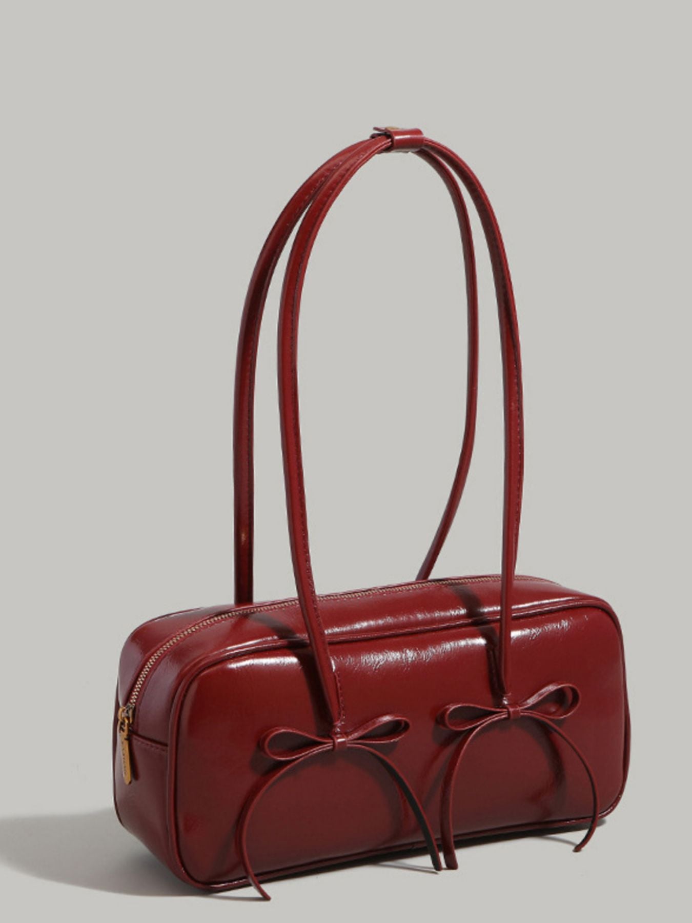 Bow decor shoulder bag with front bow detail shown standing on its own
