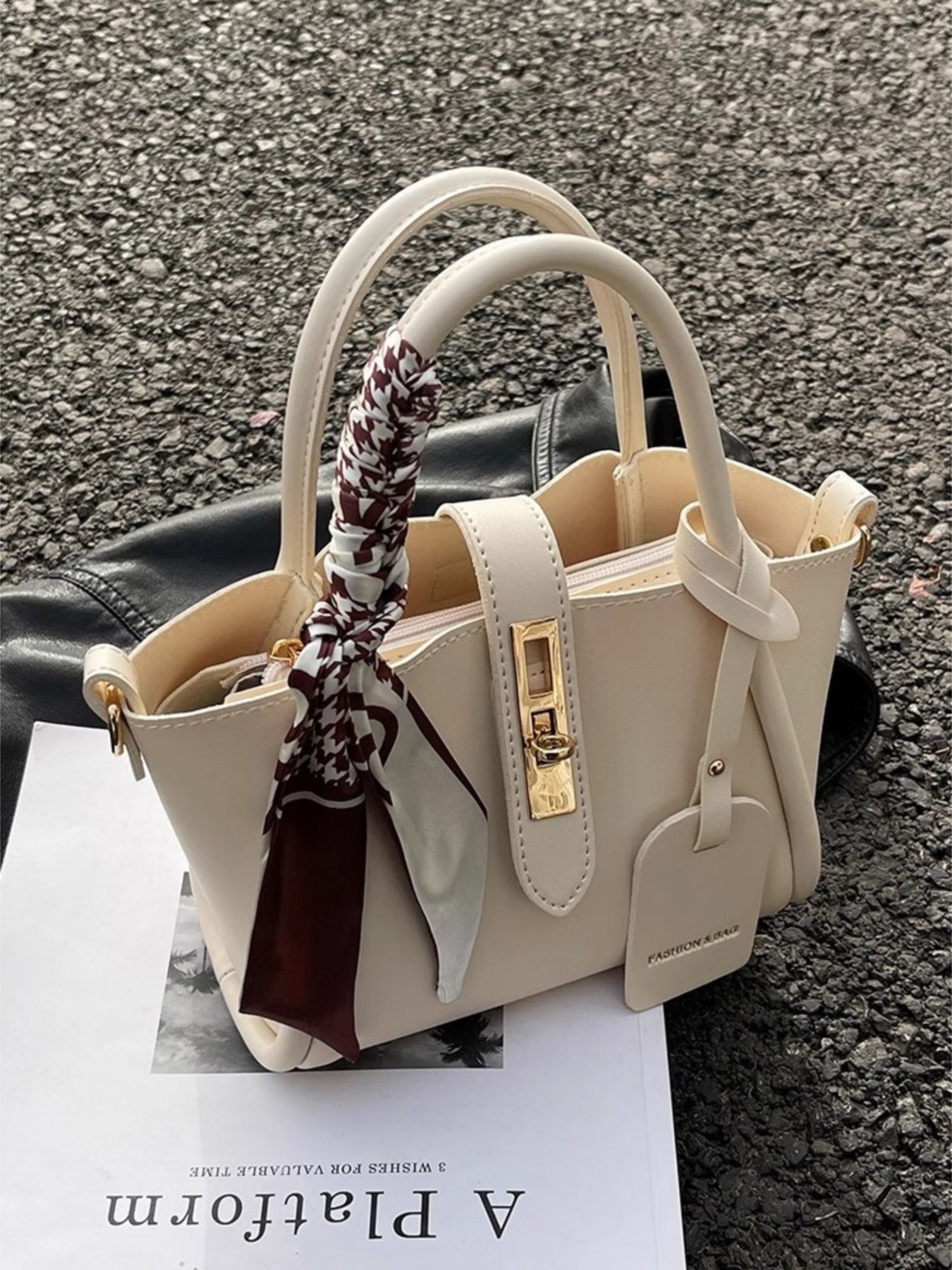 Structured mini satchel crossbody in ivory standing up on pavement