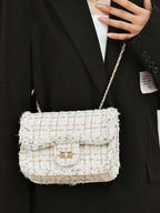 Classic tweed shoulder bag slung across chest